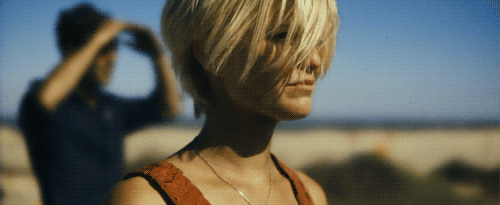 A gif of actors Scoot McNairy and Whitney Able looking at a distant explosion in the movie Monsters